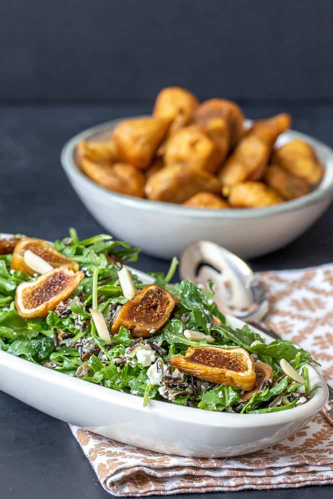 Salad with dried figs, bowl of figs behind