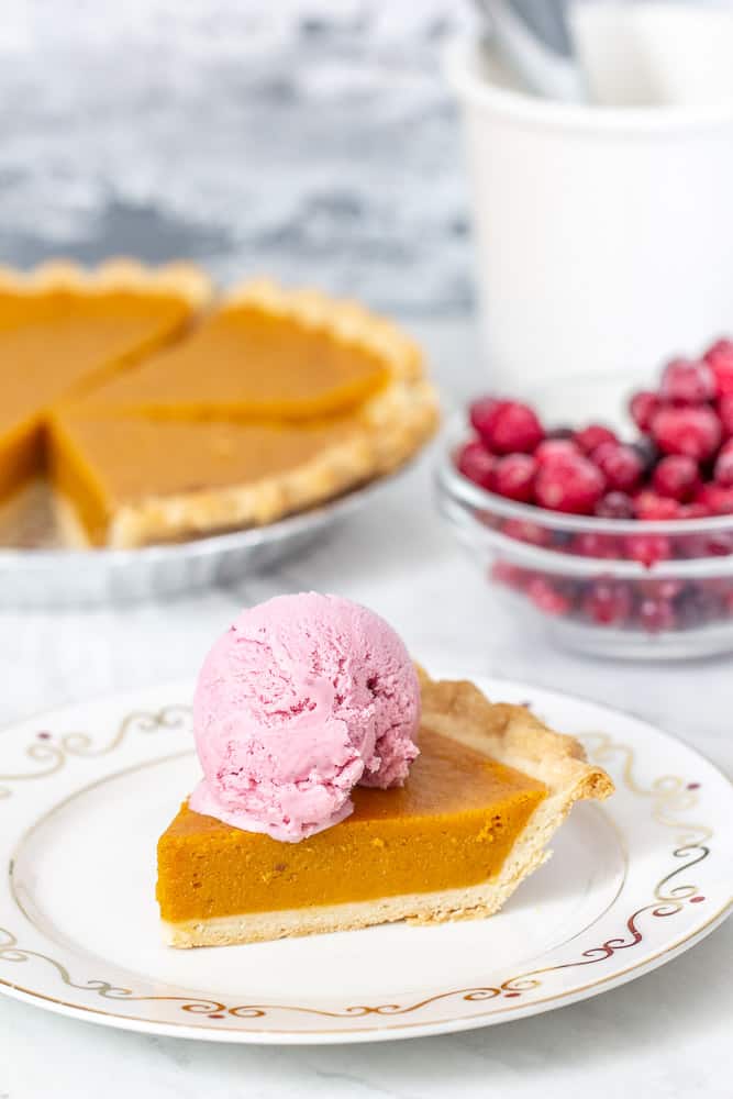 pumpkin pie, cranberries, and slice of pie with ice cream on top, vertical 