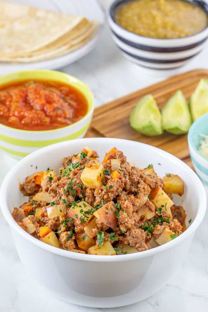 Ground bison picadillo in bowl vertical