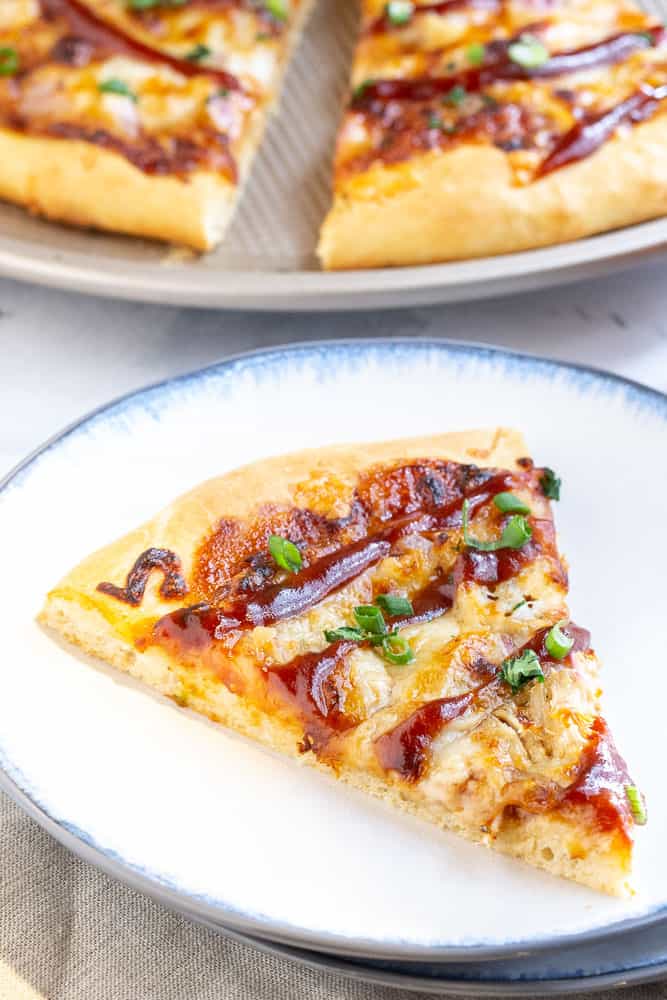 slice of bbq pulled pork pizza on a plate