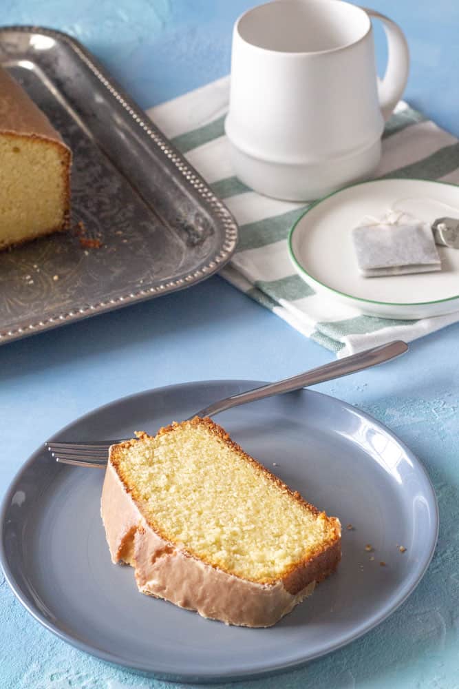 slice of cardamom tea loaf on a plate with fork