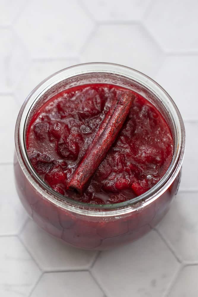 cranberry sauce in a jar with cinnamon stick