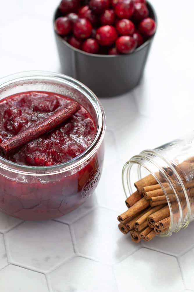 cranberry sauce with cinnamon sticks and cranberries in a bowl