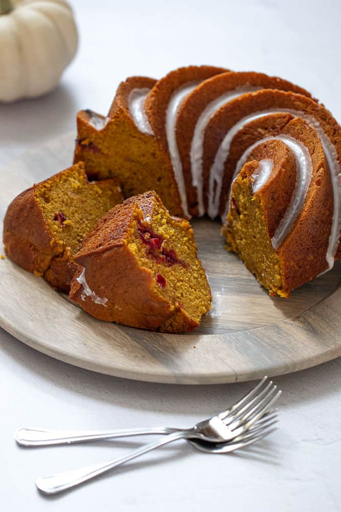 Sliced pumpkin bundt cake with cranberry swirl visible