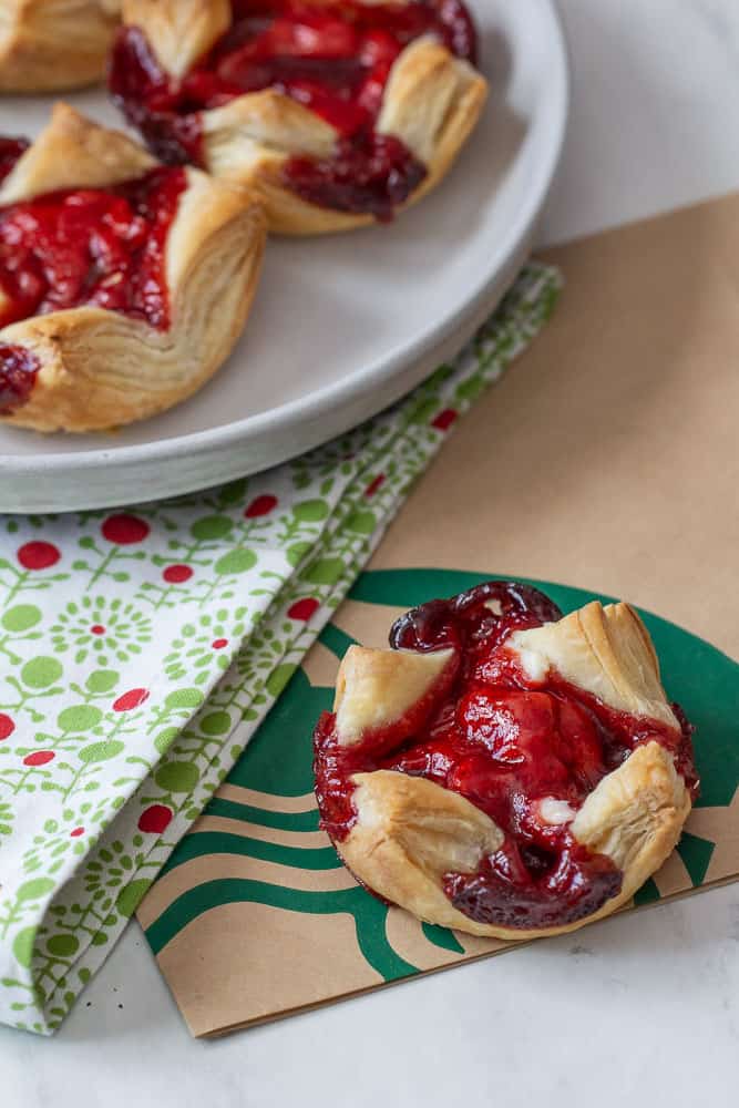 overhead sugar plum cheese danish with napkin and starbucks bag