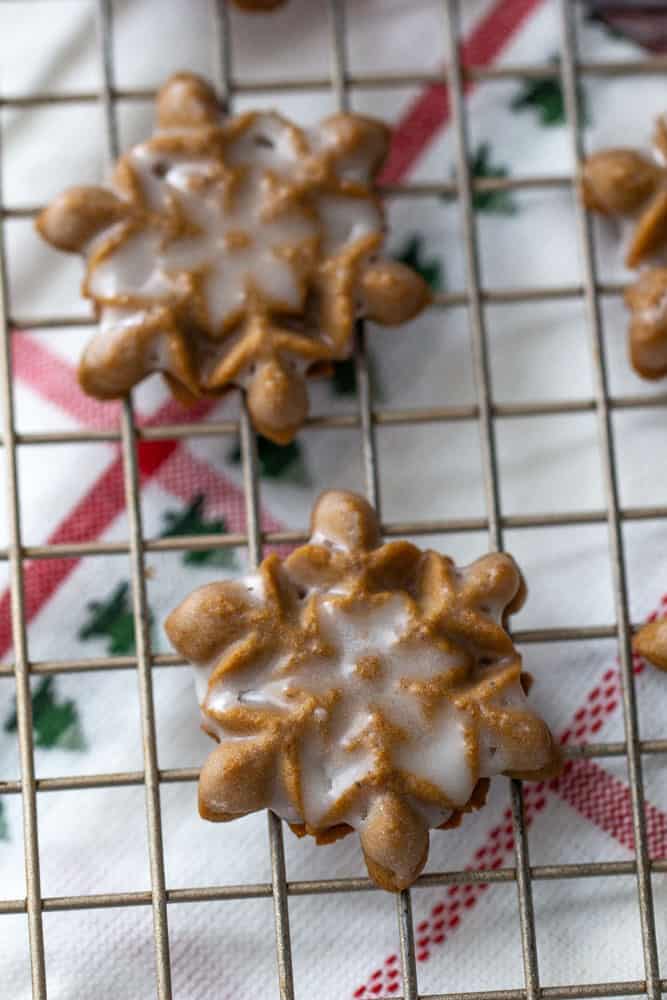 close up snowflake gingerbread spritz on a wire rack