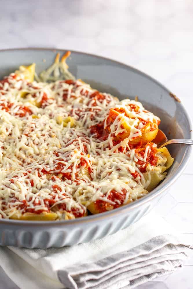 baking dish filled with stuffed shells covered in melted cheese