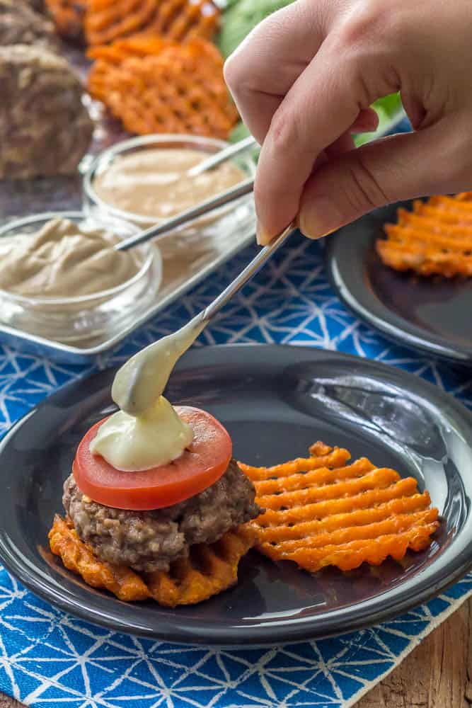 plate with slider with mayonnaise being dolloped on top