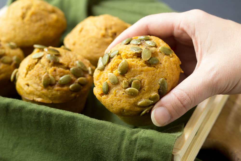 hand holding a pumpkin muffin