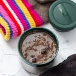 black bean soup in stanley food jar overhead, with winter gear beside