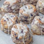 baked blueberry biscuits with icing on a baking sheet