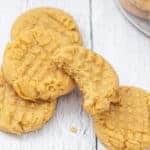 stack of peanut butter cookies with a bite out of top cookie