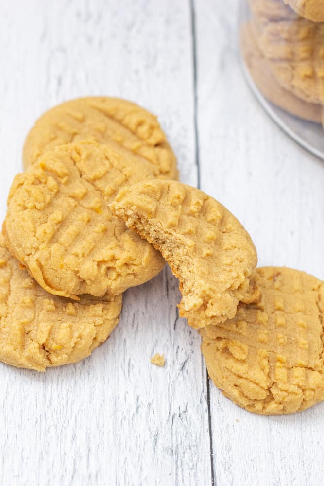 stack of peanut butter cookies with a bite out of top cookie