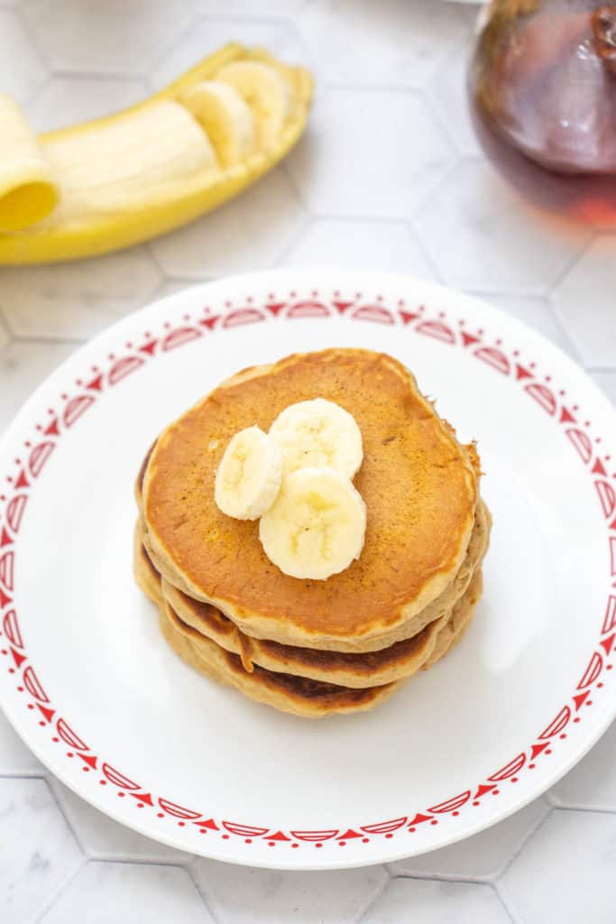 overhead of banana bread pancakes with banana slices on top