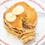 banana bread pancakes with a fork into cut pieces of pancake