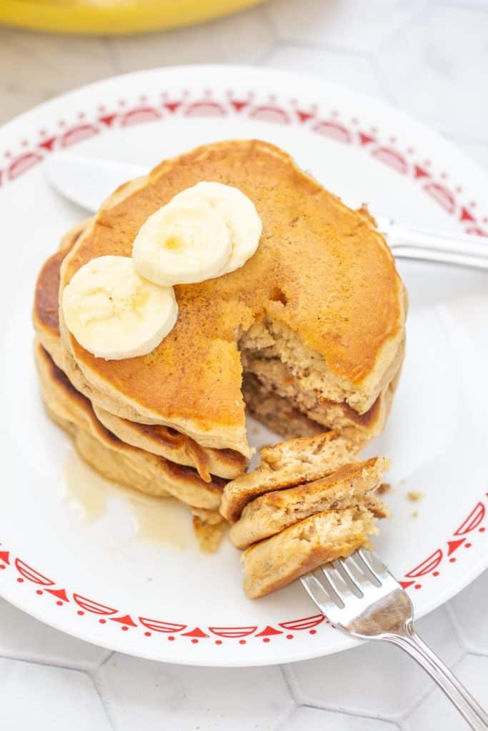 banana bread pancakes with a fork into cut pieces of pancake