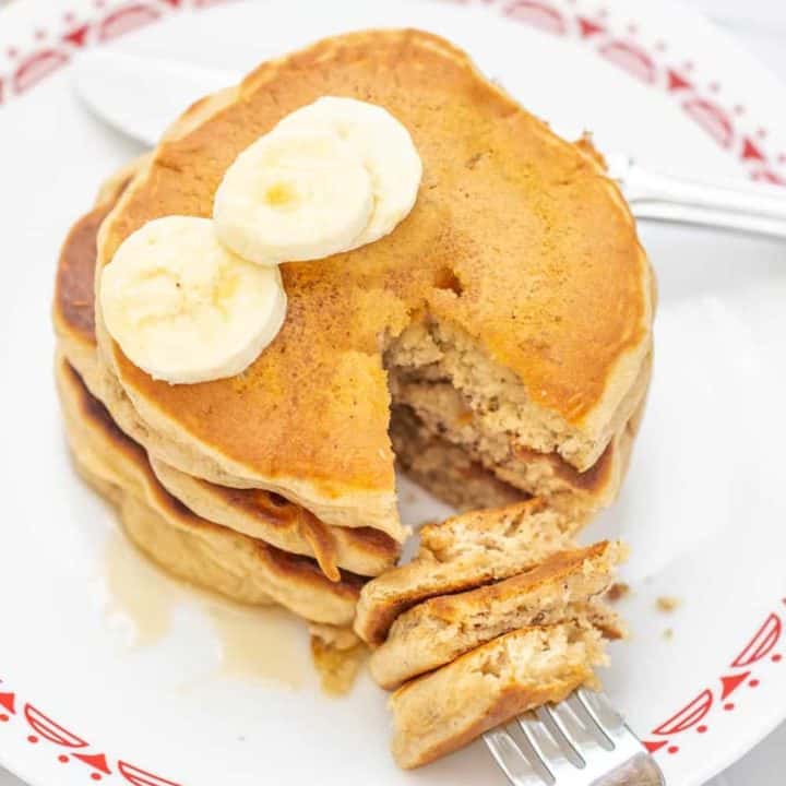 banana bread pancakes with a fork into cut pieces of pancake