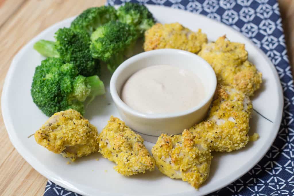 turkey nuggets with broccoli and dipping sauce on a plate