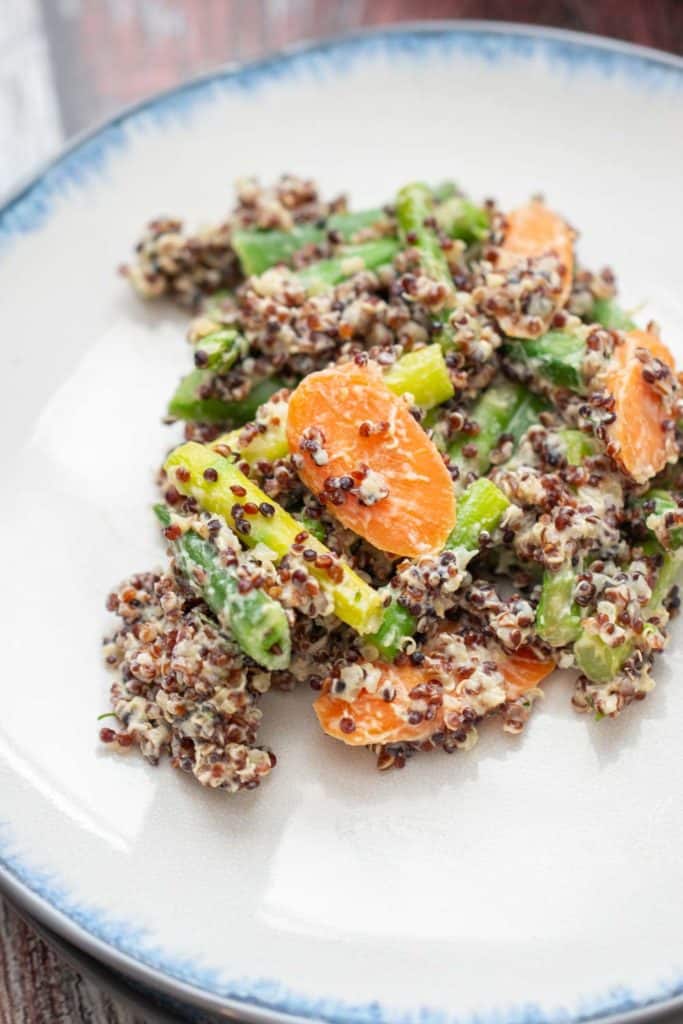 close up of quinoa primavera on a blue-edged white plate