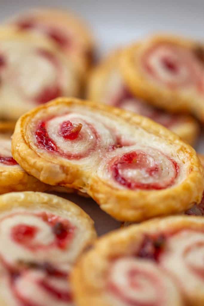 close up of strawberry jalapeno palmier stacked on others