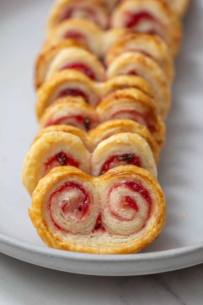 close up row of strawberry jalapeno palmiers on a plate