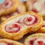 Close-up of strawberry palmiers with jalapeño, showing a swirled pattern, golden-brown pastry, and sweet-spicy strawberry filling. Text reads “Strawberry Palmier Cookies” at the top.