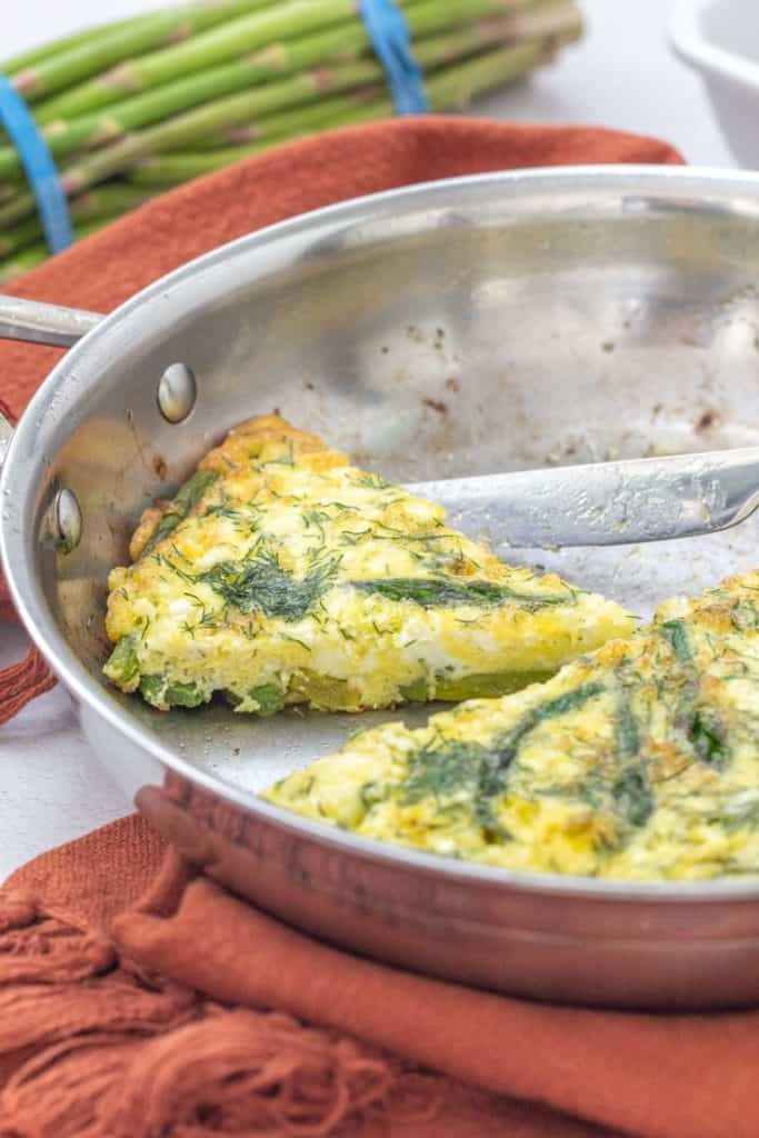 sliced asparagus dill frittata in saute pan