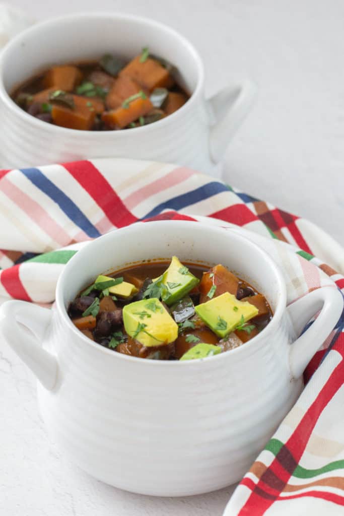 sweet potato black bean chili in white soup bowls