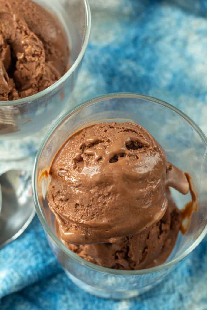 overhead of scoops of chocolate frozen yogurt in dessert bowls