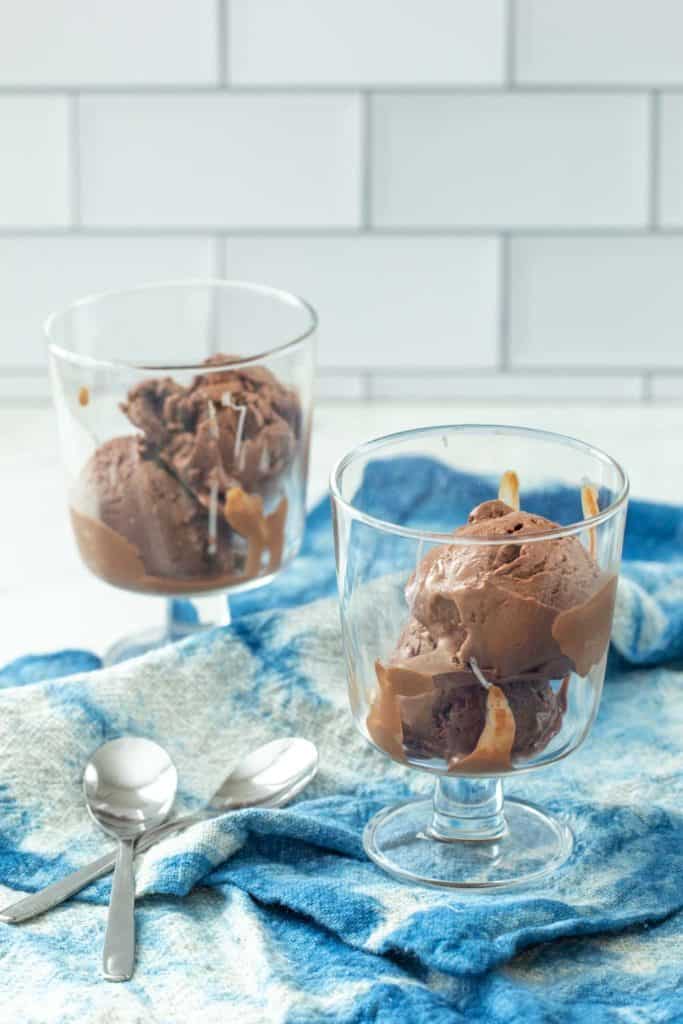 footed glass dessert bowls filled with chocolate frozen yogurt