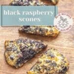 A wooden board displays several triangular black raspberry scones topped with coarse sugar. The text overlay reads "black raspberry scones" to highlight these delicious, berry-filled treats.