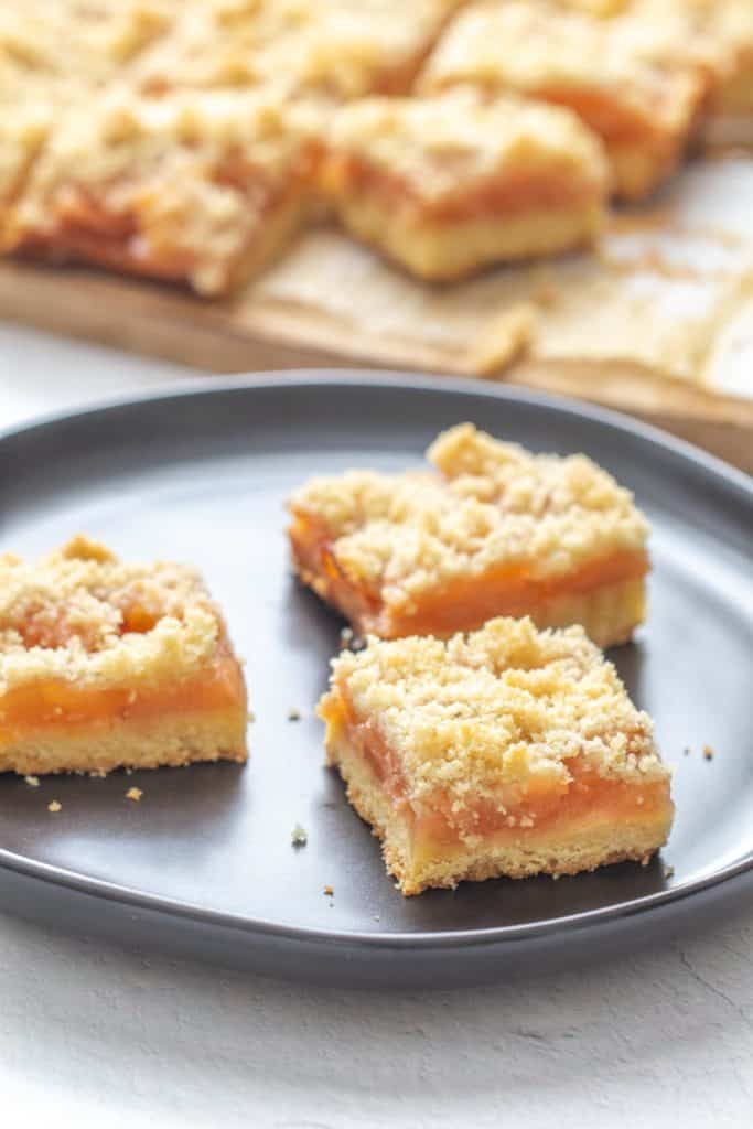 apple pie bars on a black plate