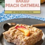 A square slice of baked peach oatmeal topped with a peach slice sits on a round metal plate, with fresh peaches in the background highlighting the homemade goodness of this baked peach oatmeal treat.
