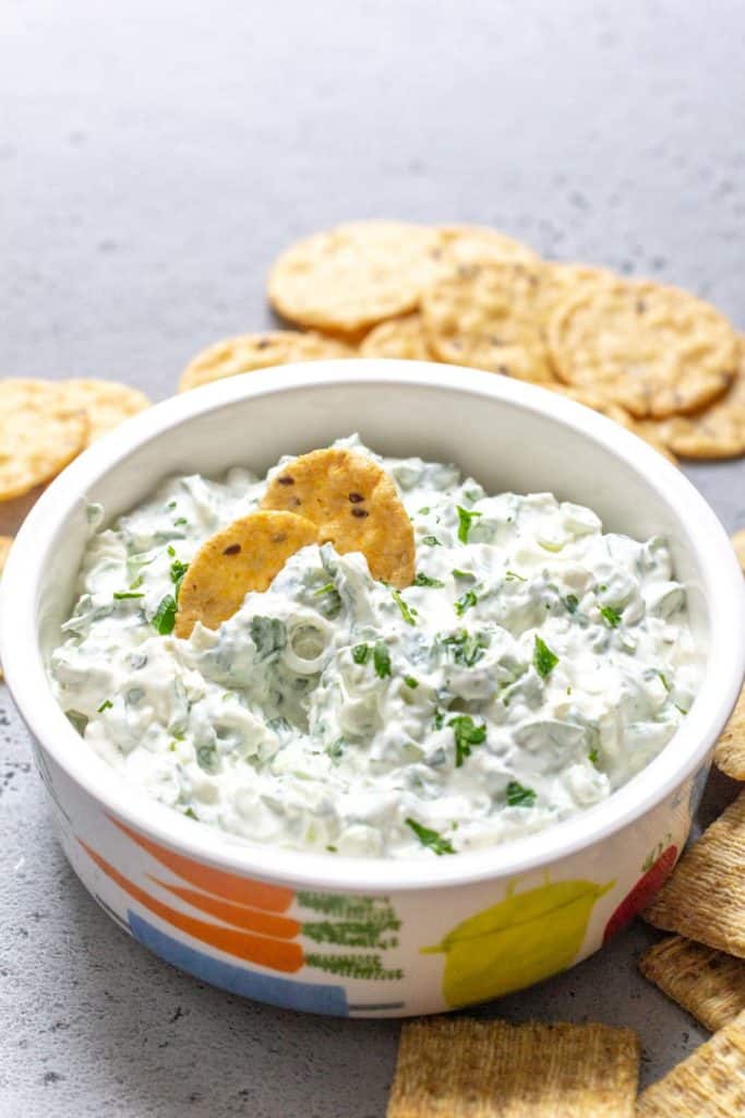 bowl of green onion dip with crackers