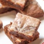 strawberry cheesecake swirl brownies stacked on a plate