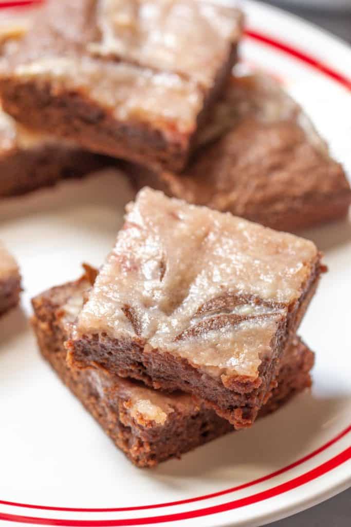 strawberry cheesecake swirl brownies stacked on a plate