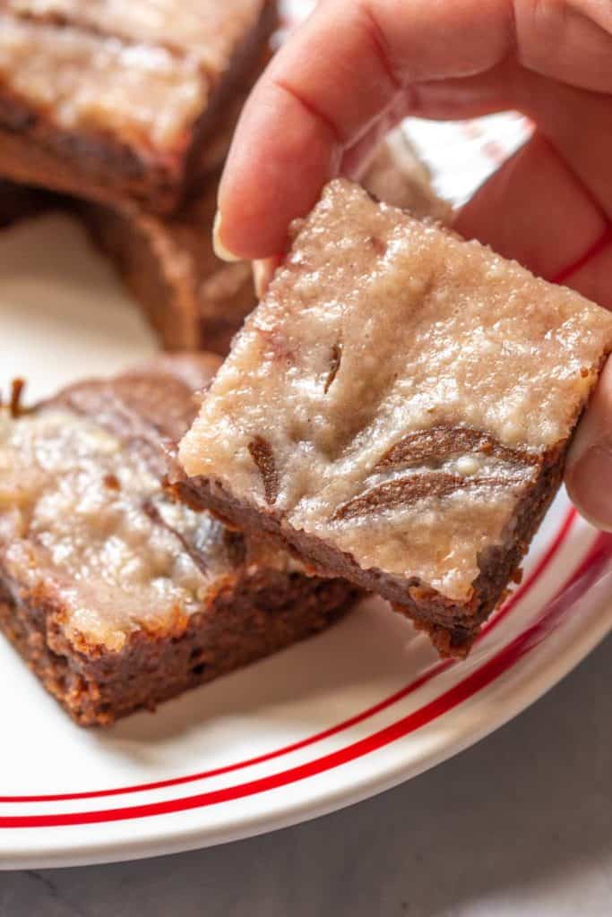 hand holding strawberry cheesecake swirl brownie