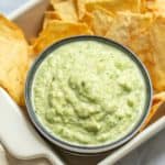 zucchini hummus in a bowl with pita chips aside