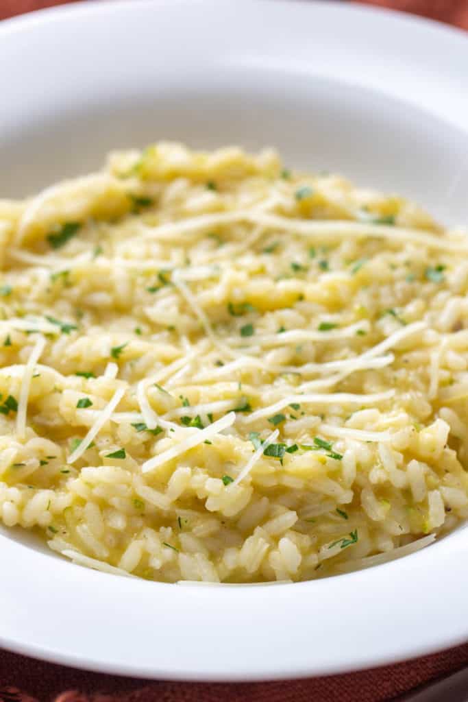 close up of zucchini risotto in a white bowl