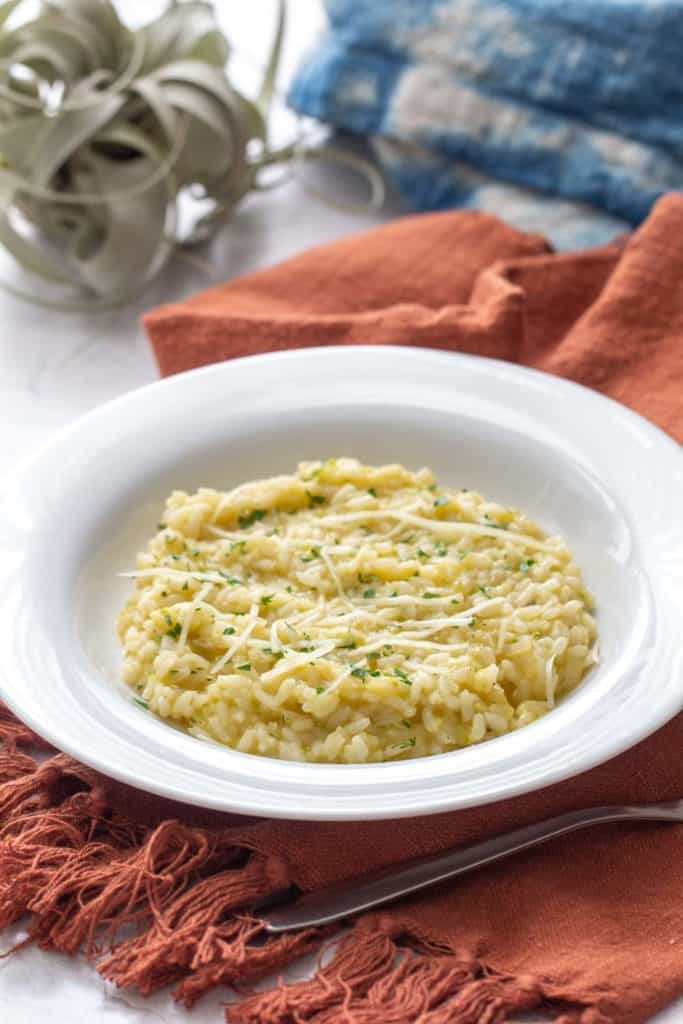 zucchini risotto in a white bowl