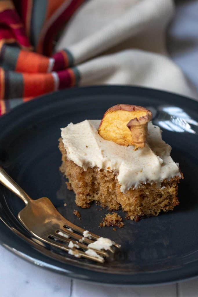 slice of apple spice cake with a bite taken out