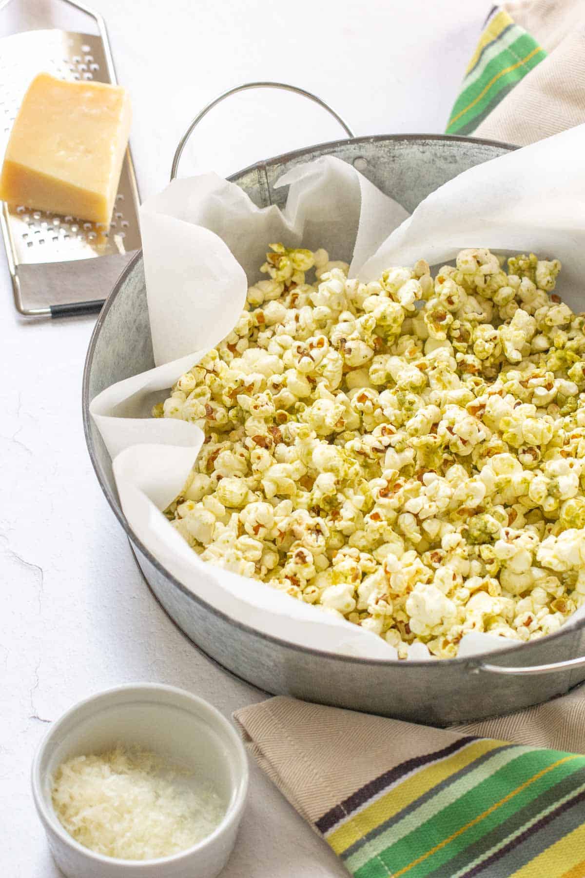 pesto popcorn in a bowl with cheese