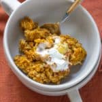 overhead pumpkin baked oatmeal in a bowl with a spoon
