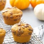 pumpkin muffins with spiced pepitas topping on a wire cooling rack