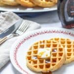 plate of peanut butter waffles with butter and syrup