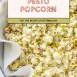 A bowl of pesto popcorn coated with green seasoning, lined with parchment paper. Text overlay reads "Pesto Popcorn. Get the recipe at stetted.com.