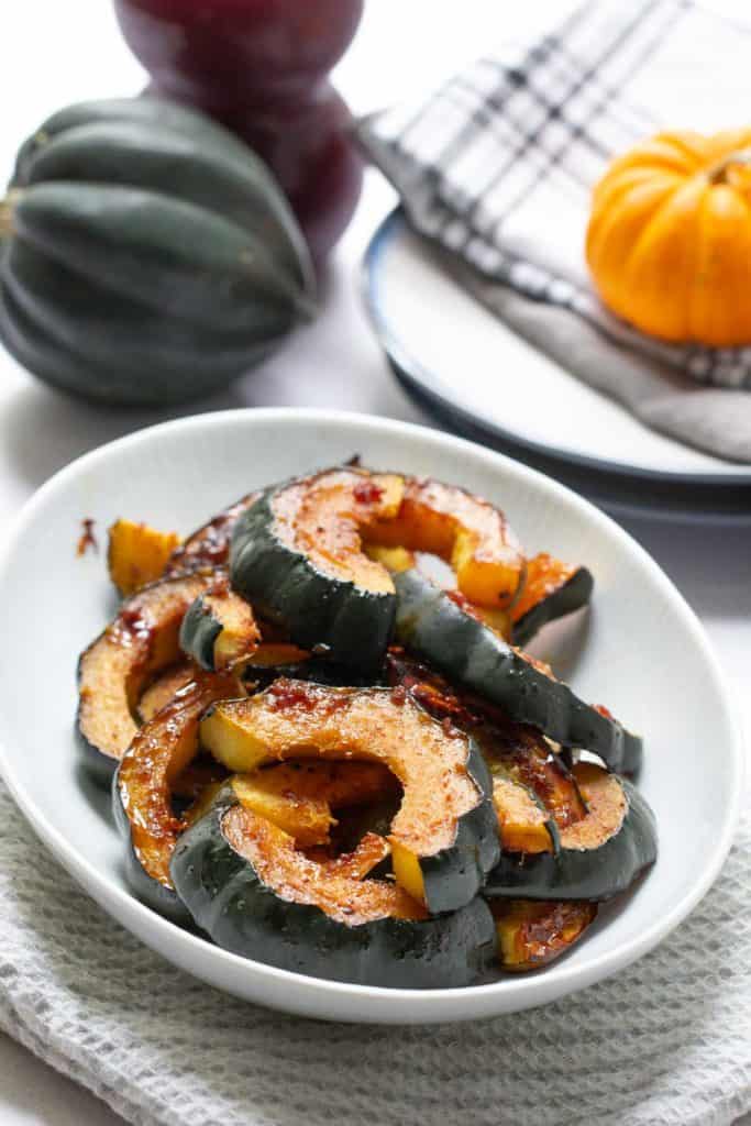 glazed acorn squash in a serving dish