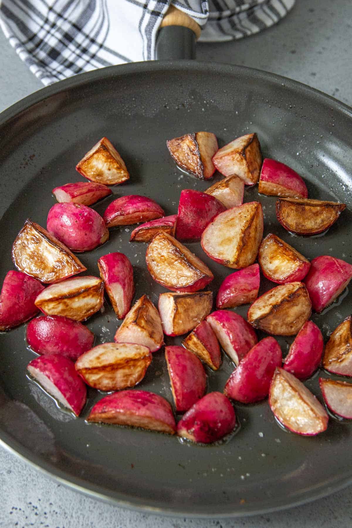 frying pan with sauteed radishes