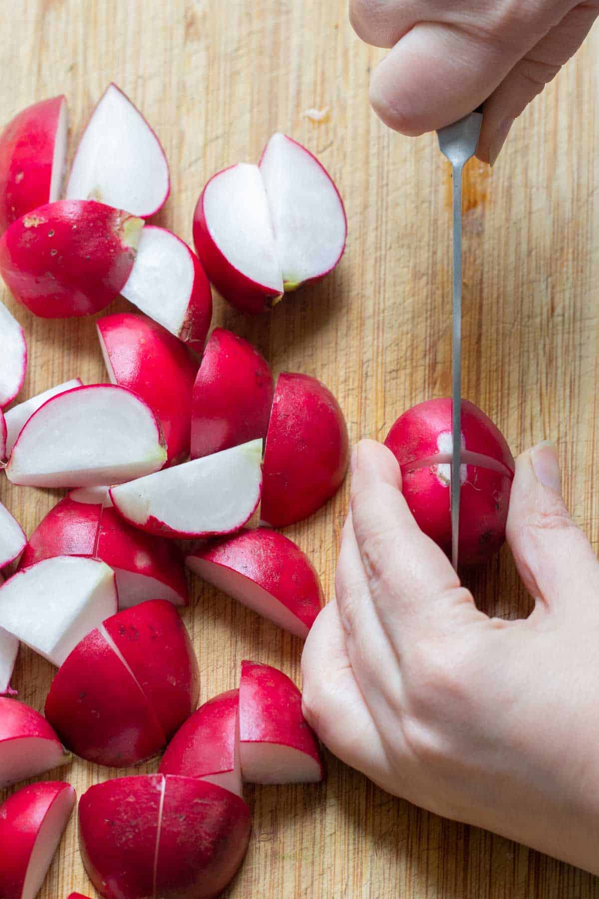 slicing radishes on cutting board