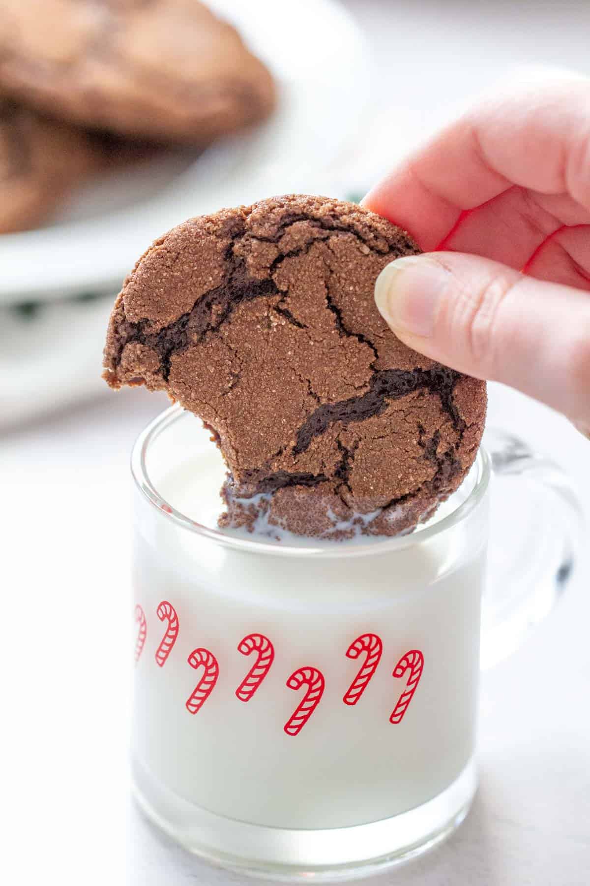 Mexican hot chocolate cookie being dipped into milk